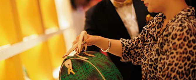 mujer comprando bolsa cara